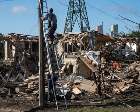 Electricians restore the power grid in front of a destroyed private house where a 14-year-old was killed in an air attack in Vyshgorod, Kyiv region.