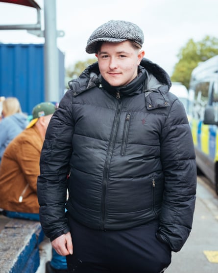 Young man in flat cap outside The Den