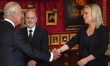The King shakes hands with Sinn Féin’s Michelle O’Neill, next to the Speaker, Alex Maskey