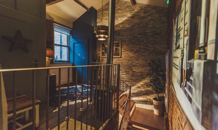 ‘All exposed brick and metal staircases.’ Interior image of Cow Hollow Hotel, Manchester.
