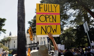 A demonstrator holds a sign during a protest calling for the reopening of California amid the Covid-19 pandemic.