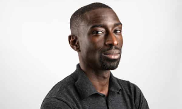 Formal portrait of Jeffrey Boakye in a grey open-necked shirt