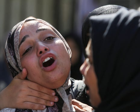 People mourn Palestinians who were killed in an incident while seeking aid in Khan Younis, at Nasser hospital in Khan Younis