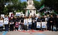 Syrian activists wearing T-shirts hold up pictures of people missing in Syria