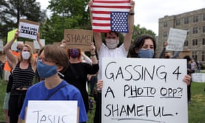 Demonstrators stage a protest near the Saint John Paul II National Shrine, where President Donald Trump planned a visit on Tuesday.