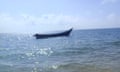 A capsized boat in the sea.