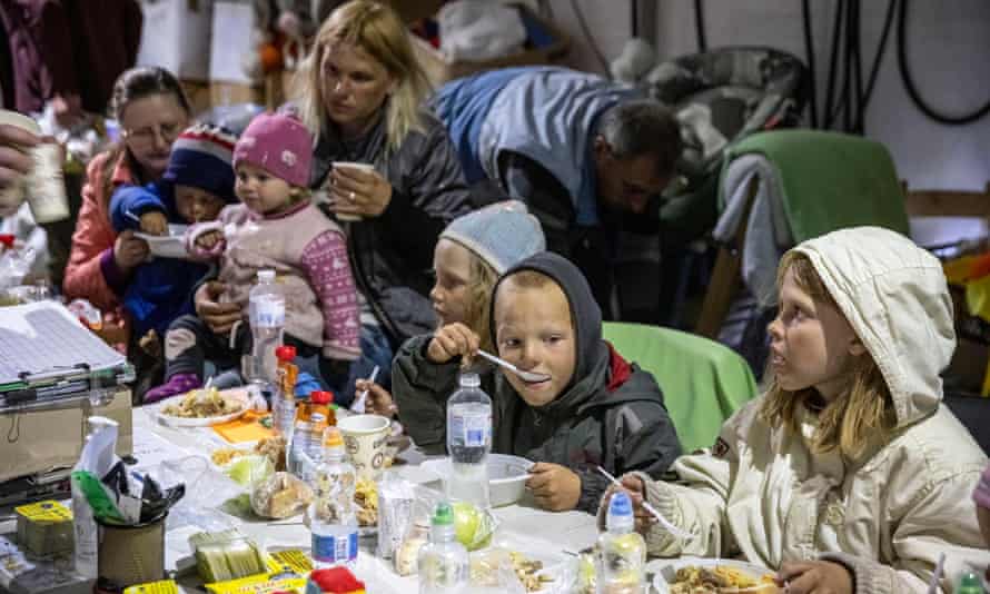 Children eat a meal at a large table