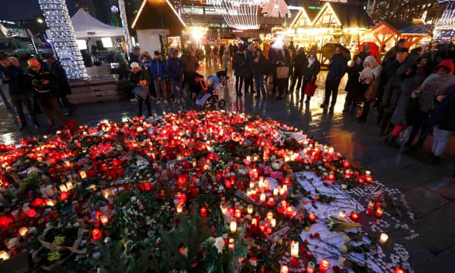 Flowers and candles are placed at the Christmas market at Breitscheid square in Berlin following an attack by a truck which ploughed through a crowd at the market on Monday night