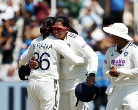 Sneh Rana celebrates with Richa Ghosh and Deepti Sharma after taking the wicket of England's Sophie Ecclestone to win the match.
