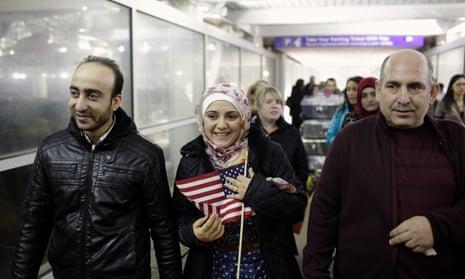 Syrian refugee Baraa Haj Khalaf holds the American flag