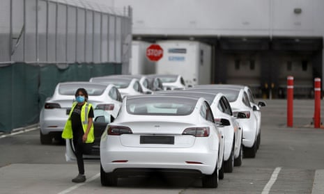 A worker exits a Tesla vehicle at the company’s primary factory in Fremont, California, on 11 May. 