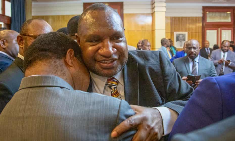 James Marape is hugged by a supporter after being sworn in as the new prime minister of Papua New Guinea.