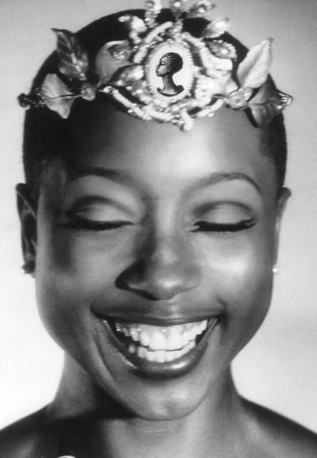 woman wearing crown smiling with eyes closed in portrait