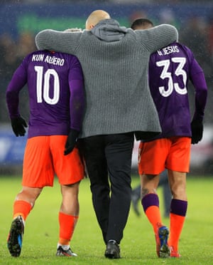 Pep Guardiola embraces Sergio Aguero and Gabriel Jesus after City’s 3-2 win.