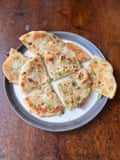 Even though Ken Hom’s scallion pancakes eschew the usual layering of the dough, they are ‘pretty tasty nonetheless’.