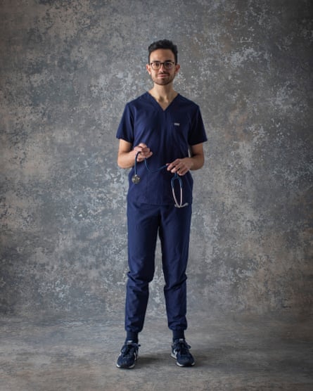 Dr Vassili Crispi wearing scrubs and holding a stethoscope