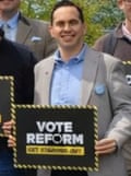 Closeup of man holding a ‘Vote Reform’ sign with 3 fingers in AI manipulated image of Reform UK supporters as posted by Richard Tice