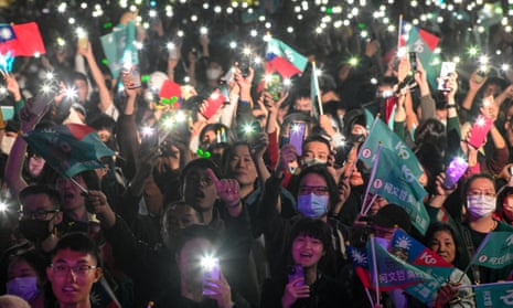Supporters of the Taiwan People's party wave flags during a campaign rally