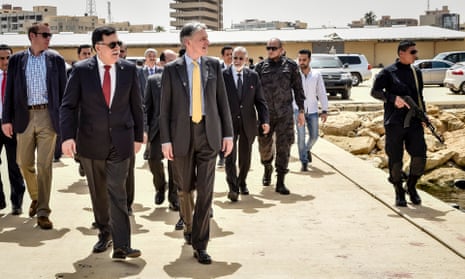 Philip Hammond (centre) tours a naval base with Libya’s prime minister designate Fayez al-Sarraj on a visit to Tripoli last week.