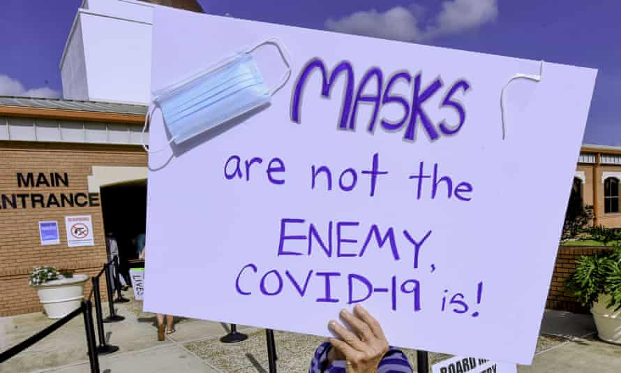 A protester holds a placard outside an emergency meeting of the Brevard county school board in Viera in August 2021 to discuss whether face masks in local schools should be mandatory.