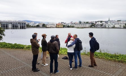 A tour party at the edge of Tjörnin in Reykjavik, and close to the Alþingi, which houses Iceland’s parliament.