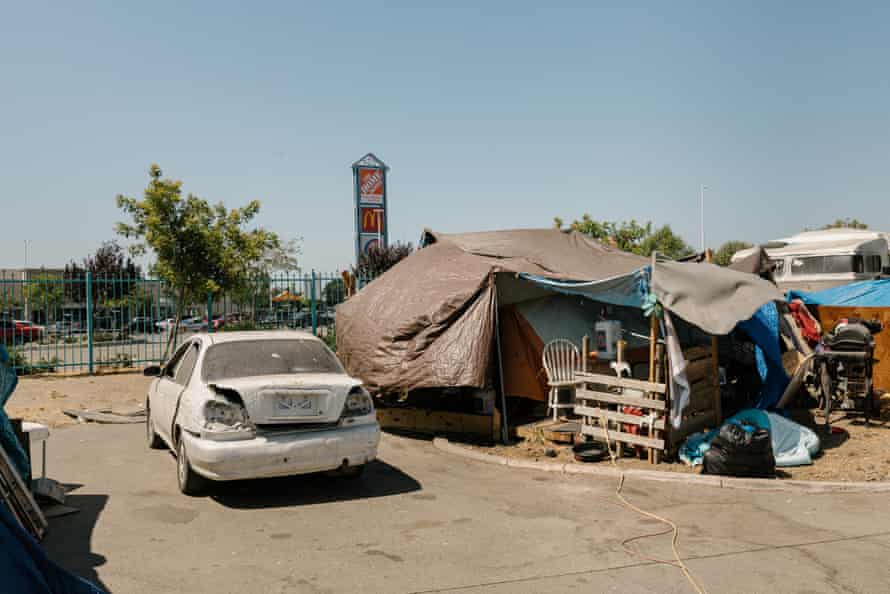 Abandoned cars dot the Community of Grace encampment near a Home Depot in Oakland, California.
