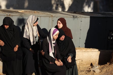Relatives of the Palestinians who died mourn as bodies are brought to the al-Shifa hospital for burial in Gaza City on 20 December.