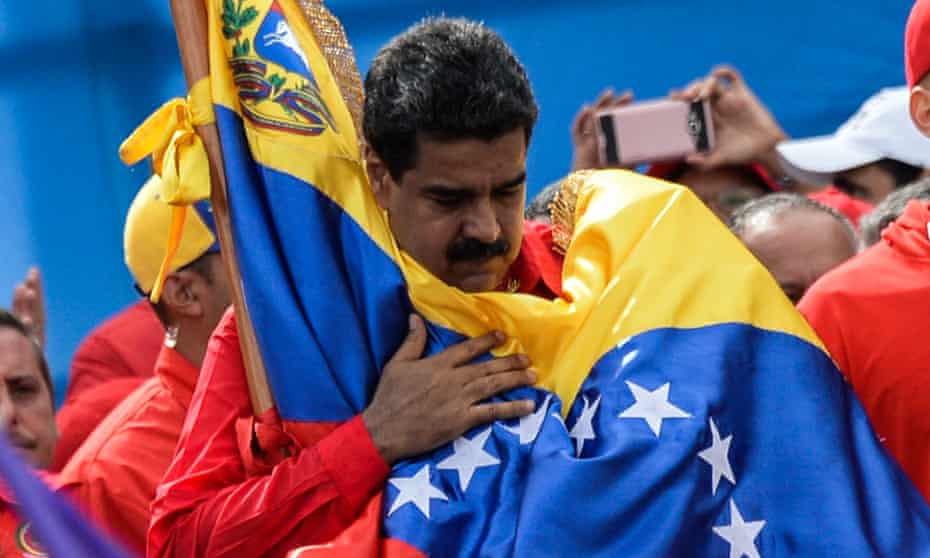 Venezuela’s President Nicolas Maduro holds a national flag during the closing of the campaign to elect a constituent assembly.