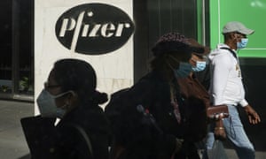 Pedestrians walk past the Pfizer world headquarters in New York City.