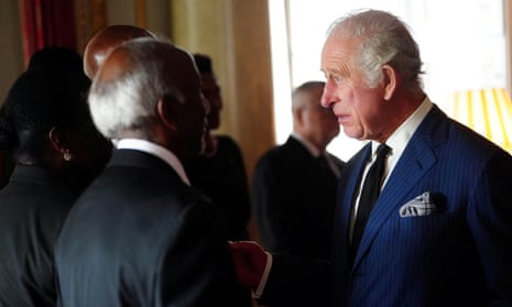 King Charles attends a reception with High Commissioners and their spouses in the Bow Room at Buckingham Palace.