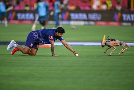 Rajasthan Royalsâ Kumar Kartikeya interacts with the robot dog Champak before the start of the IPL match between Rajasthan Royals and Gujarat Titans.