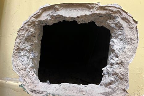 A large square-shaped hole in the middle of a concrete wall