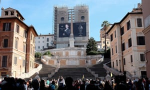 Tourists stand in front of the Spanish Steps in Rome