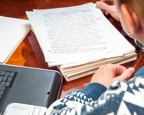 An author with her manuscript and a laptop