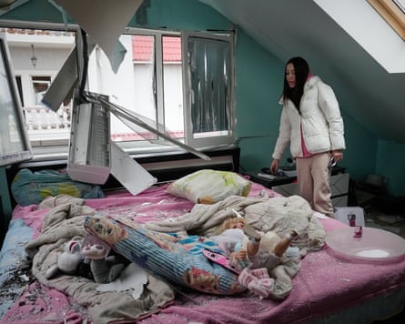 A woman looks at her damaged apartment on Thursday after a Russian missile attack in Kyiv, Ukraine.