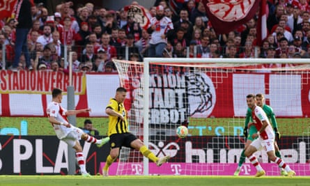 Dejan Ljubicic scores Cologne’s third goal at home to Dortmund.