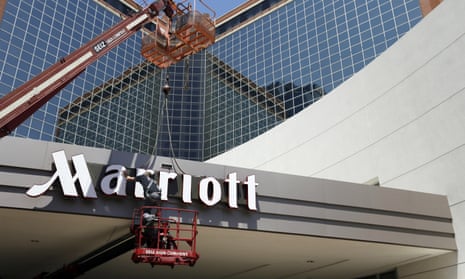 A man works on a new Marriott sign