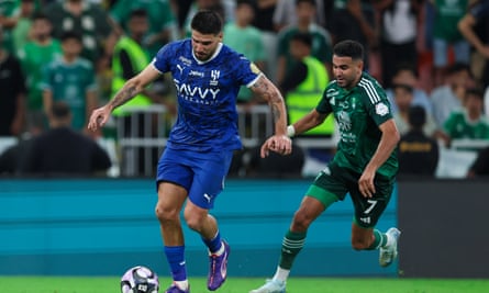 Al Ahli’s Riyad Mahrez runs after Al-Hilal’s Aleksandar Mitrovic.