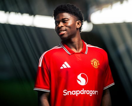 Carlos Baleba poses after signing for Manchester United