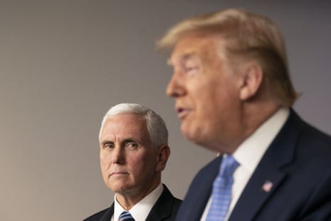 Mike Pence listens as Donald Trump, right, speaks during a news conference in the press briefing room of the White House in Washington DC.