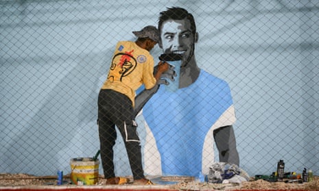 Artist Mohammed Mahmoud paints a mural of Cristiano Ronaldo in Benghazi, Libya.