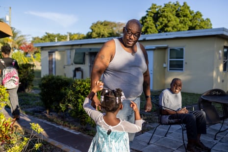 A man interacting with his daugther outside