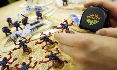 A customer uses a tape measure to play Warhammer in a London Games Workshop store in London.
