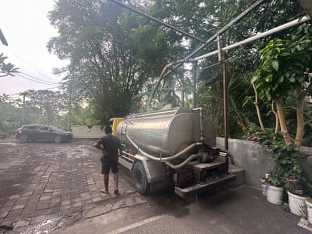 Water truck in muddy lane