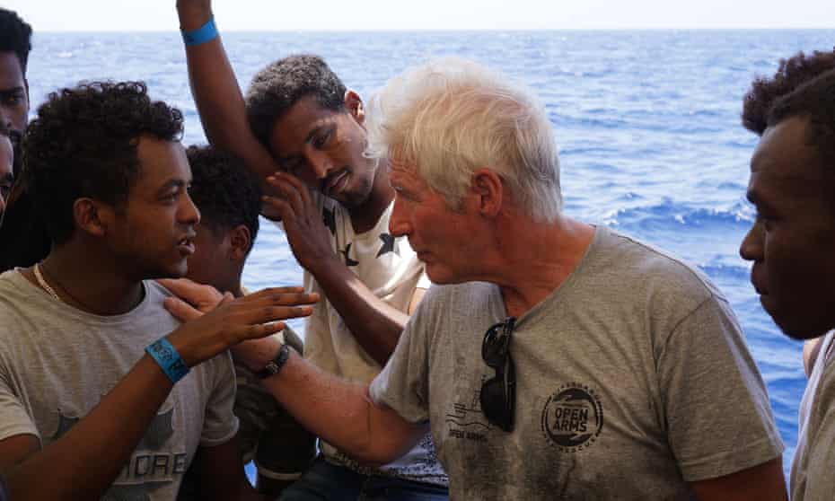 Richard Gere and migrants are seen onboard the Spanish NGO tugboat Open Arms