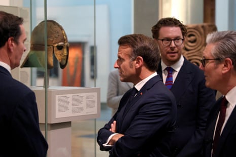 Emmanuel Macron and Keir Starmer looking astatine nan Sutton Hoo helmet successful nan British Museum this day – 1 of nan objects going to France connected indebtedness successful return for nan Bayeux Tapestry coming to nan UK.
