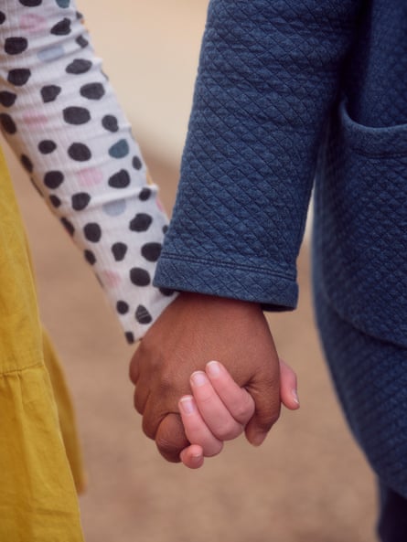 Andrea Harris Smith holding her daughter’s hand.