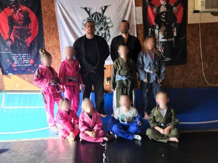 two men and eight children pose for a photograph