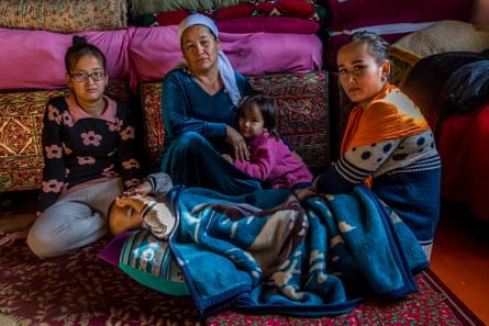 The Oralman family of Zukhra Mukanova (blue scarf), in the living room of the family home in the village of Chubarsu, a few kilometres from Chymkent.