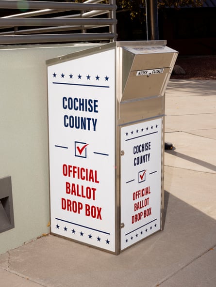 Big metal standing drop box, covered with white panels that say in red and blue ‘Conchise County Official Ballot Drop Box’